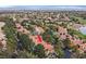 Expansive aerial view of an elegant home showcasing its red-tiled roof and lush landscaping in a beautiful community at 9044 Opus Dr, Las Vegas, NV 89117