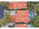 Aerial view of a home featuring red tile roof, landscaped yard, pool, and spa at 9044 Opus Dr, Las Vegas, NV 89117