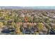 Aerial view of neighborhood with tiled roofs and mature trees at 9044 Opus Dr, Las Vegas, NV 89117