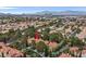 Well-maintained property with a clay tile roof, mature trees, and tasteful landscaping in a well-planned community at 9044 Opus Dr, Las Vegas, NV 89117
