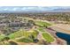 Scenic aerial view of a neighborhood with a golf course and lush mature trees at 9044 Opus Dr, Las Vegas, NV 89117