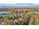 Lush residential neighborhood with tiled roofs, mature trees, and a golf course in the background at 9044 Opus Dr, Las Vegas, NV 89117