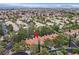 Bird's eye of homes with red tile roofs and mature trees in a suburban neighborhood at 9044 Opus Dr, Las Vegas, NV 89117