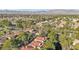 Beautiful aerial view of neighborhood with lush green trees and mountain views at 9044 Opus Dr, Las Vegas, NV 89117