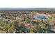 Stunning aerial view of a luxury community featuring beautiful homes, a lush golf course, and a serene lake at 9044 Opus Dr, Las Vegas, NV 89117