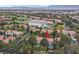 Lushly landscaped home with a sparkling pool provides a serene view, backing onto a scenic golf course and lake at 9044 Opus Dr, Las Vegas, NV 89117