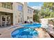 Inviting backyard with pool, spa, covered patio, and outdoor fireplace, perfect for entertaining at 9044 Opus Dr, Las Vegas, NV 89117