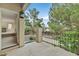 Balcony with metal railing overlooking trees and quiet neighborhood street at 9044 Opus Dr, Las Vegas, NV 89117