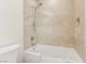 Modern bathroom features a soaking tub with tile surround and a shower head at 9044 Opus Dr, Las Vegas, NV 89117