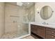 This bathroom features a glass shower, double vanity, and modern lighting at 9044 Opus Dr, Las Vegas, NV 89117