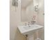 Elegant bathroom features a pedestal sink with chrome fixtures and modern sconces at 9044 Opus Dr, Las Vegas, NV 89117