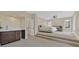 Open bedroom with elevated platform, wet bar, and abundant natural light at 9044 Opus Dr, Las Vegas, NV 89117