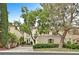 Two-story stucco home featuring a red tile roof and mature landscaping in a suburban neighborhood at 9044 Opus Dr, Las Vegas, NV 89117