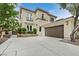 Elegant two-story home boasts a two-car garage, stone accents, and manicured landscaping at 9044 Opus Dr, Las Vegas, NV 89117