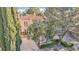 Aerial view of a charming two-story home featuring a tiled roof and landscaped front yard at 9044 Opus Dr, Las Vegas, NV 89117