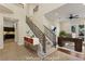 Bright foyer featuring a staircase with wrought iron railing and adjacent office space at 9044 Opus Dr, Las Vegas, NV 89117