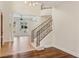 Bright foyer features staircase, chandelier, and tile flooring that leads to an open living space at 9044 Opus Dr, Las Vegas, NV 89117