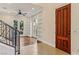Stairway to the foyer with hardwood floors, a ceiling fan, and built-in shelving at 9044 Opus Dr, Las Vegas, NV 89117