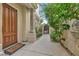 Inviting front entrance with a solid wood door, stone pillar, and a 'Welcome' mat at 9044 Opus Dr, Las Vegas, NV 89117