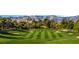 Scenic golf course with lush green fairways, mature trees and mountain views at 9044 Opus Dr, Las Vegas, NV 89117