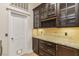 This elegant kitchen features custom cabinets, granite countertops, and a convenient butler's pantry at 9044 Opus Dr, Las Vegas, NV 89117