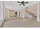 Expansive living room with tiled floors, high ceilings, and an elegant staircase at 9044 Opus Dr, Las Vegas, NV 89117