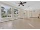 Spacious living room featuring tile floors, large windows, and modern ceiling fan at 9044 Opus Dr, Las Vegas, NV 89117