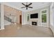 Open-concept living room with fireplace, built-in shelves, and staircase at 9044 Opus Dr, Las Vegas, NV 89117