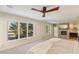 Open main bedroom featuring a stone fireplace and large windows with a beautiful view at 9044 Opus Dr, Las Vegas, NV 89117