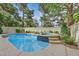 Backyard pool and hot tub with mature landscaping, a serene outdoor retreat at 9044 Opus Dr, Las Vegas, NV 89117