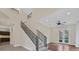 Elegant staircase leading to an open landing with abundant light at 9044 Opus Dr, Las Vegas, NV 89117