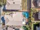 A beautiful aerial view of a home's roof and backyard with pool, patio, landscaping, and privacy fence at 9417 Grenville Ave, Las Vegas, NV 89134