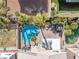 Aerial view of backyard pool and spa with a covered patio, green grass, and desert landscaping at 9417 Grenville Ave, Las Vegas, NV 89134