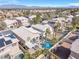 An aerial view of a backyard pool, covered patio, and desert landscaping in a residential neighborhood at 9417 Grenville Ave, Las Vegas, NV 89134