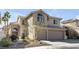 Charming two-story home with a three-car garage, well-kept landscaping, and an inviting facade in a serene neighborhood at 9417 Grenville Ave, Las Vegas, NV 89134