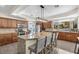 Modern kitchen with granite countertops, stainless steel appliances, and a central island at 9417 Grenville Ave, Las Vegas, NV 89134