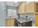 Bright laundry room with ample cabinet space, stainless steel washer and dryer, and a utility sink at 9417 Grenville Ave, Las Vegas, NV 89134