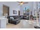 Bright living room featuring a vaulted ceiling, large windows, and comfortable seating at 9417 Grenville Ave, Las Vegas, NV 89134