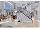 Open living room showcasing a staircase, modern table, and plenty of natural light at 9417 Grenville Ave, Las Vegas, NV 89134