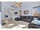 Open living room showcasing tile floors, a large sectional sofa, and plenty of natural light at 9417 Grenville Ave, Las Vegas, NV 89134
