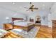 Spacious main bedroom with an ensuite bathroom, a ceiling fan, and light hardwood floors at 9417 Grenville Ave, Las Vegas, NV 89134