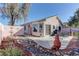 Charming backyard featuring a water fountain, rock landscaping, and outdoor dining area at 9695 Allison Ranch Ave, Las Vegas, NV 89148