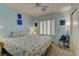 Light-filled bedroom featuring bright blue walls, a comfortable bed, and stylish decor at 9695 Allison Ranch Ave, Las Vegas, NV 89148