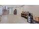 Spacious finished basement with neutral paint, laminate floors and access to the upper floors via carpeted staircase at 9835 Fox Estate St, Las Vegas, NV 89141