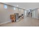 Bright finished basement features durable laminate floors and a carpeted staircase leading to the upper levels at 9835 Fox Estate St, Las Vegas, NV 89141