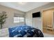 Cozy bedroom features neutral walls, carpet floors, and a TV for relaxation and entertainment at 9835 Fox Estate St, Las Vegas, NV 89141