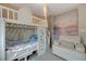 room featuring a house style bunkbed with a comfy chair and beach themed artwork at 9835 Fox Estate St, Las Vegas, NV 89141