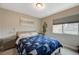 Comfortable bedroom featuring neutral walls, carpet floors, and a window for natural light at 9835 Fox Estate St, Las Vegas, NV 89141