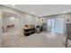 Expansive bonus room featuring neutral walls, vinyl floors, and a sliding glass door to the backyard at 9835 Fox Estate St, Las Vegas, NV 89141