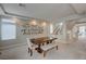 Bright dining room featuring a large wooden table, comfortable seating, and stylish decorative shelving at 9835 Fox Estate St, Las Vegas, NV 89141